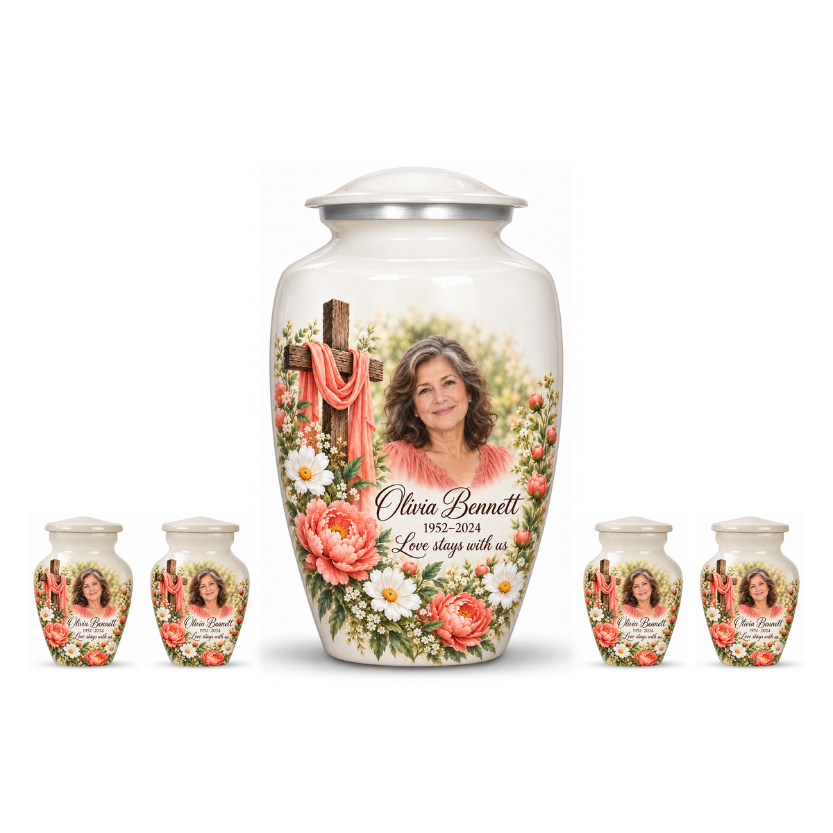 One white adult cross urn and four keepsakes with coral flowers and white daisies arranged on white.