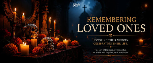 Day of the Dead remembrance altar with candles, decorative skulls, marigold flowers, and Remembering Loved Ones memorial banner