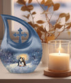 A unique Penguin themed Cross Drop Memorial Urn