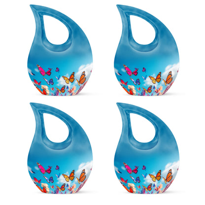 Slate Blue Butterfly Cremation Urn lifestyle display on memorial shelf - cross and butterfly combined in spiritual memorial design - 10 inch aluminum urn for cremated remains