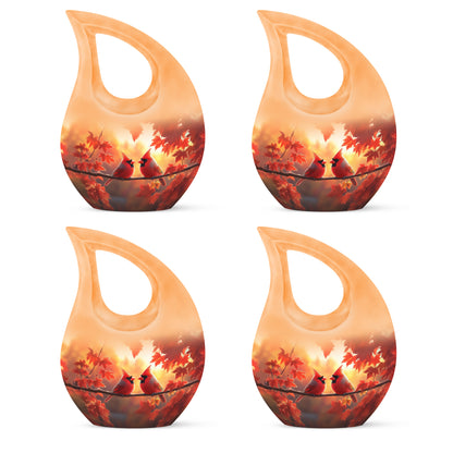 Sunrise Gold Cardinal Cremation Urn lifestyle display on memorial shelf - sacred cross merged with cardinal motif on metal - 10 inch aluminum urn for cremated remains