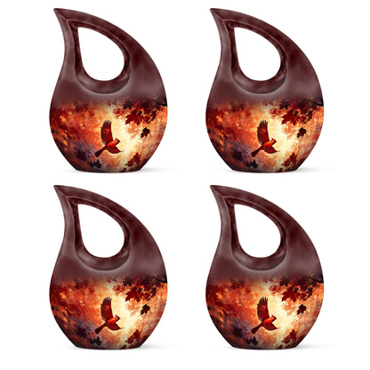 Burgundy Red Cardinal Cremation Urn lifestyle display on memorial shelf - sacred cross merged with cardinal motif on metal - 10 inch aluminum urn for cremated remains