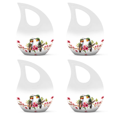 Chrome Silver Hummingbird Cremation Urn lifestyle display on memorial shelf - faith-inspired cross-drop urn with hummingbird pattern - 10 inch aluminum urn for cremated remains