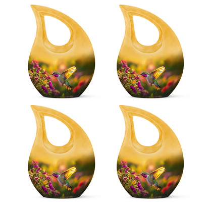 Harvest Gold Hummingbird Cremation Urn lifestyle display on memorial shelf - faith-inspired cross-drop urn with hummingbird pattern - 10 inch aluminum urn for cremated remains