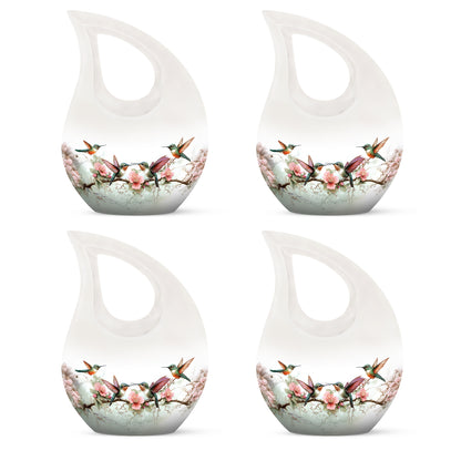 Brushed Silver Hummingbird Cremation Urn lifestyle display on memorial shelf - cross and hummingbird combined in spiritual memorial design - 10 inch aluminum urn for cremated remains