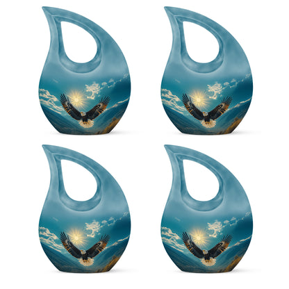 Soft Teal Eagle Cremation Urn lifestyle display on memorial shelf - sacred cross merged with eagle motif on metal - 10 inch aluminum urn for cremated remains