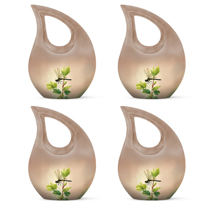 Amber Gold Dragonfly Cremation Urn lifestyle display on memorial shelf - cross and dragonfly combined in spiritual memorial design - 10 inch aluminum urn for cremated remains