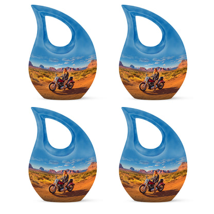 Powder Blue Bike Cremation Urn lifestyle display on memorial shelf - sacred cross merged with bike motif on metal - 10 inch aluminum urn for cremated remains