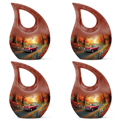 Amber Gold Car Cremation Urn lifestyle display on memorial shelf - sacred cross merged with car motif on metal - 10 inch aluminum urn for cremated remains