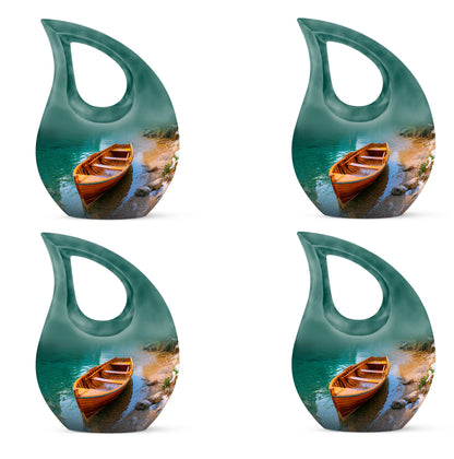 Ocean Teal Boat Cremation Urn lifestyle display on memorial shelf - cross and boat combined in spiritual memorial design - 10 inch aluminum urn for cremated remains