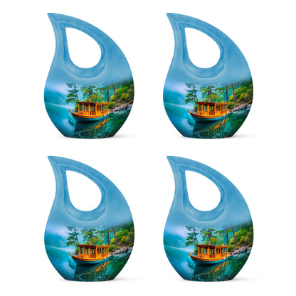 Cool Teal Boat Cremation Urn lifestyle display on memorial shelf - cross and boat combined in spiritual memorial design - 10 inch aluminum urn for cremated remains