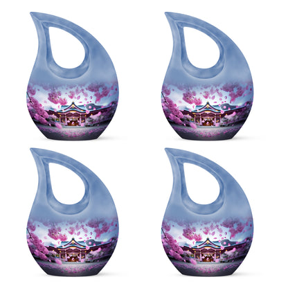 Dusty Pink Cherry Blossom Cremation Urn lifestyle display on memorial shelf - devotional cross-drop cherry blossom engraving - 10 inch aluminum urn for cremated remains