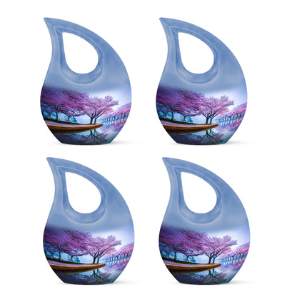Royal Blue Cherry Blossom Cremation Urn lifestyle display on memorial shelf - devotional cross-drop cherry blossom engraving - 10 inch aluminum urn for cremated remains