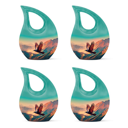 Sea Green Teal Crow Cremation Urn lifestyle display on memorial shelf - cross and crow combined in spiritual memorial design - 10 inch aluminum urn for cremated remains