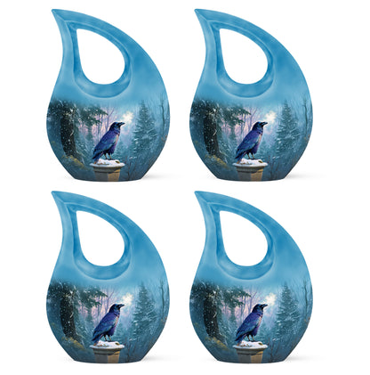 Dusty Blue Crow Cremation Urn lifestyle display on memorial shelf - sacred cross merged with crow motif on metal - 10 inch aluminum urn for cremated remains