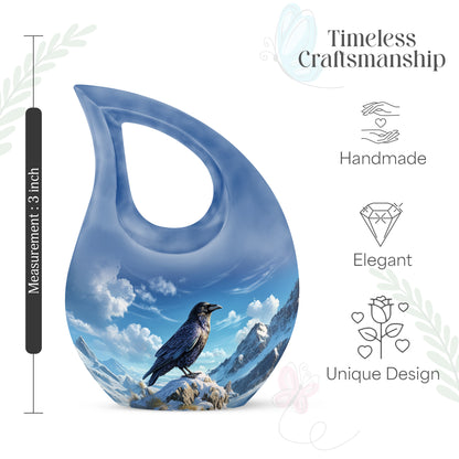 Sky Blue Crow Cremation Urn back view with polished surface - sacred cross merged with crow motif on metal - mini keepsake memorial for portion of cremation ashes