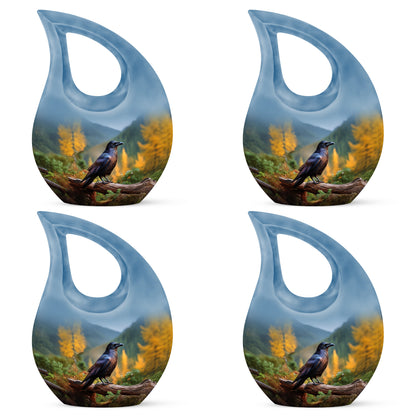 Sky Blue Crow Cremation Urn lifestyle display on memorial shelf - sacred cross merged with crow motif on metal - 10 inch aluminum urn for cremated remains