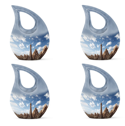 Serene Blue Eiffel Tower Cremation Urn lifestyle display on memorial shelf - devotional cross-drop eiffel tower engraving - 10 inch aluminum urn for cremated remains