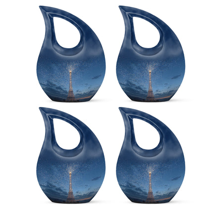 Misty Blue Eiffel Tower Cremation Urn lifestyle display on memorial shelf - sacred cross merged with eiffel tower motif on metal - 10 inch aluminum urn for cremated remains