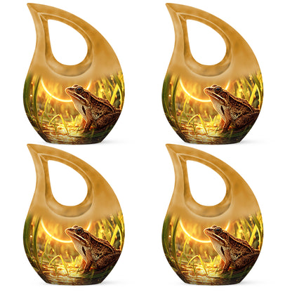 Amber Gold Frog Cremation Urn lifestyle display on memorial shelf - cross and frog combined in spiritual memorial design - 10 inch aluminum urn for cremated remains