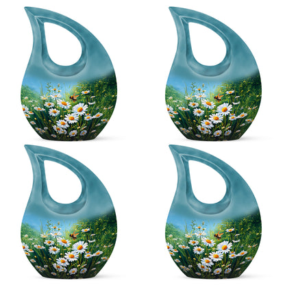 Soft Teal Daisy Cremation Urn lifestyle display on memorial shelf - cross and daisy combined in spiritual memorial design - 10 inch aluminum urn for cremated remains