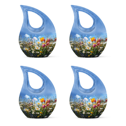Dusty Blue Garden Tulip Cremation Urn lifestyle display on memorial shelf - cross and garden tulip combined in spiritual memorial design - 10 inch aluminum urn for cremated remains