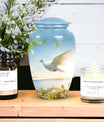 Image of dove-designed metal urn for human ashes, an elegant funerary urn suitable for adult men