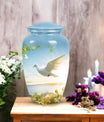 Image of dove-designed metal urn for human ashes, an elegant funerary urn suitable for adult men