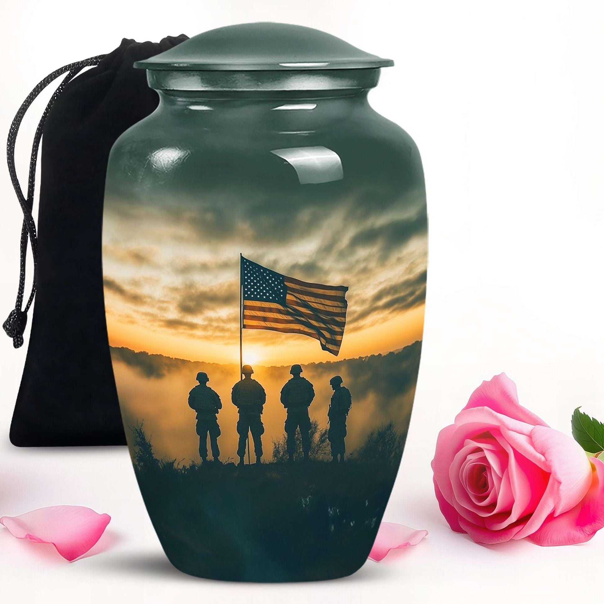 Cremation urn with American flag and soldiers design, accompanied by a pink rose and black bag.