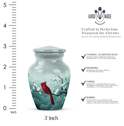 Gleaming Silver Cardinal Cremation Urn close-up of engraving and surface detail - classic sculpted cardinal pattern on smooth aluminum - mini keepsake memorial for portion of cremation ashes