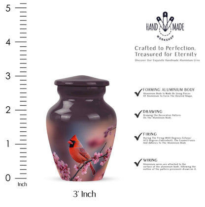 Pastel Pink Cardinal Cremation Urn close-up of engraving and surface detail - timeless cardinal motif etched into premium metal - mini keepsake memorial for portion of cremation ashes