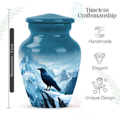 Dusty Blue Crow Cremation Urn close-up of engraving and surface detail - classic sculpted crow pattern on smooth aluminum - mini keepsake memorial for portion of cremation ashes
