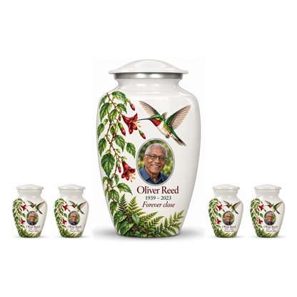One white hummingbird adult urn with four matching keepsakes, all with Oliver Reed sample photo and text