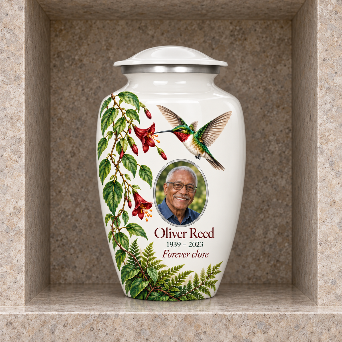 White hummingbird adult urn with Oliver Reed sample photo and text displayed in a stone columbarium niche