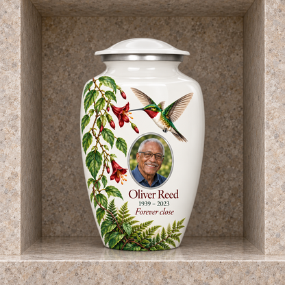 White hummingbird adult urn with Oliver Reed sample photo and text displayed in a stone columbarium niche
