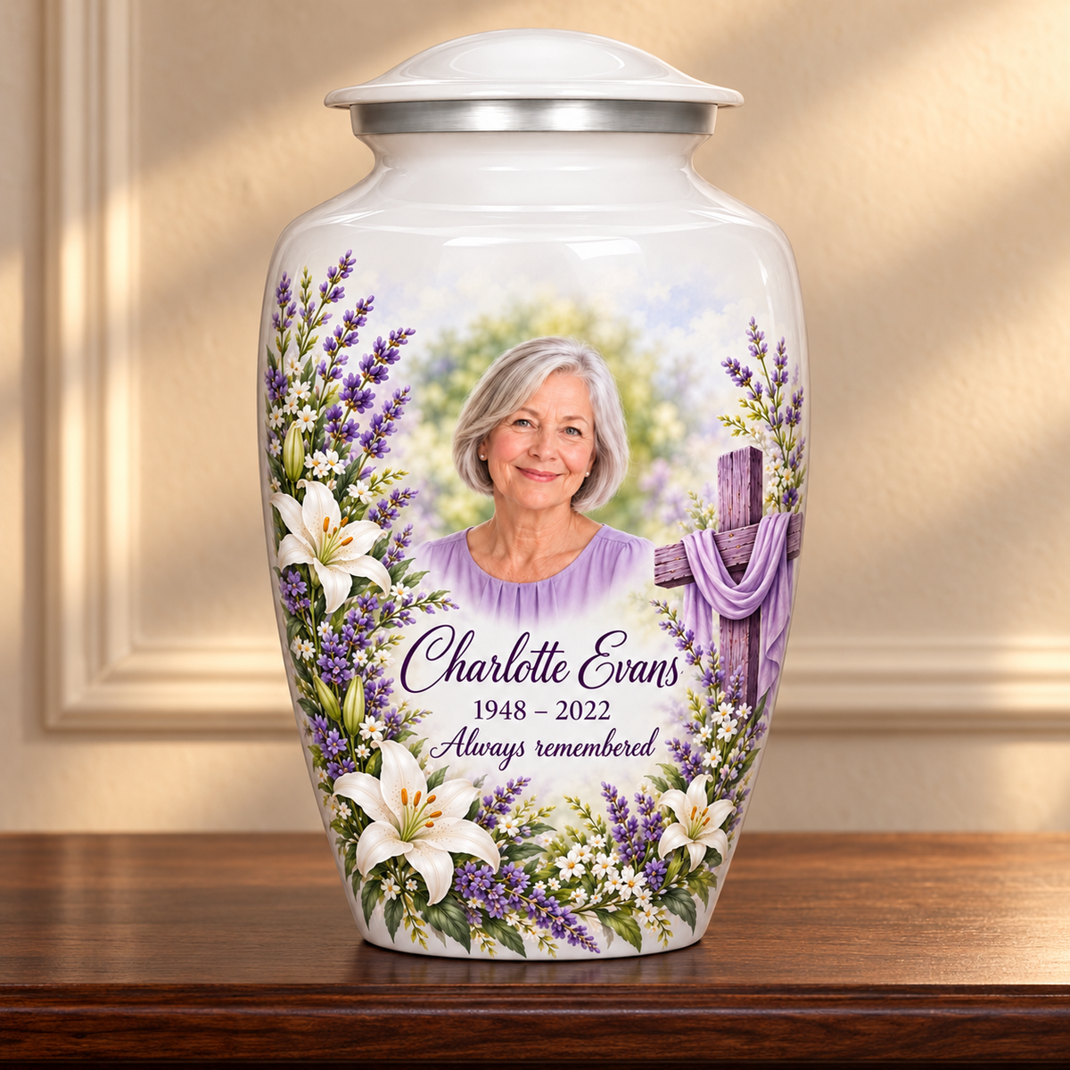 White adult cross urn with white lilies and lavender displayed on a memorial console.