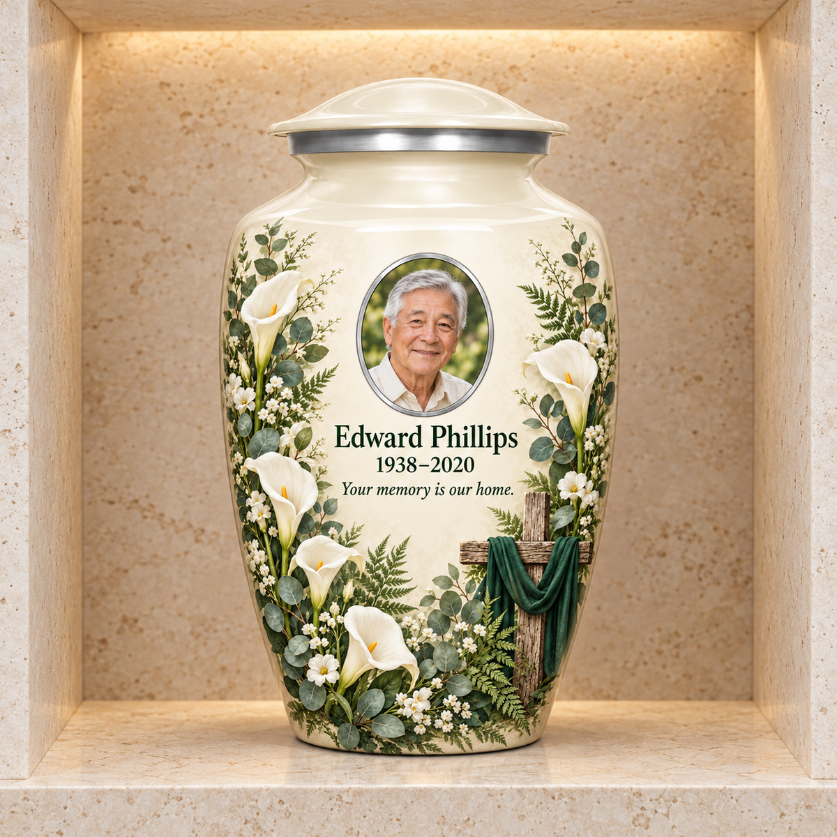 White adult cross urn with white calla lilies and greenery displayed in a stone columbarium niche.