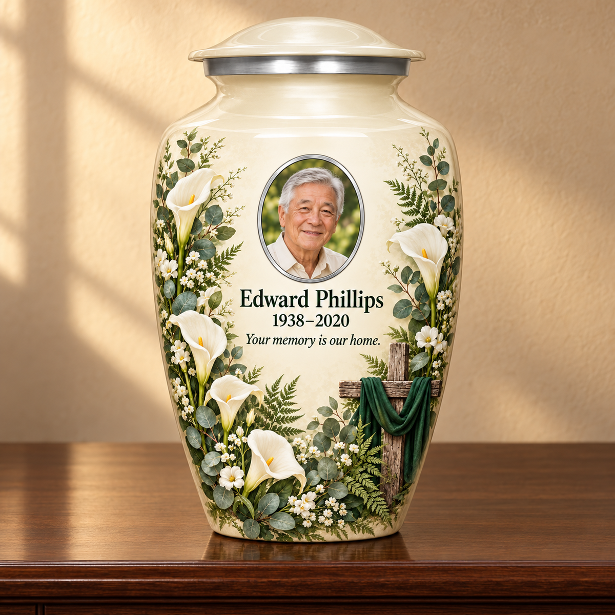 White adult cross urn with white calla lilies and greenery displayed on a memorial console.
