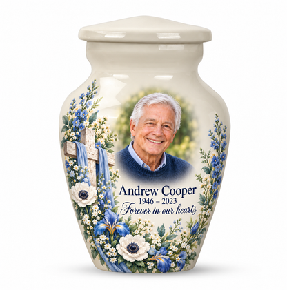 One white cross keepsake urn with blue and white flowers, sample portrait and tribute on white.