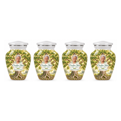 Four matching White Elm Tree of Life keepsake urns with sample photo and text on a white background