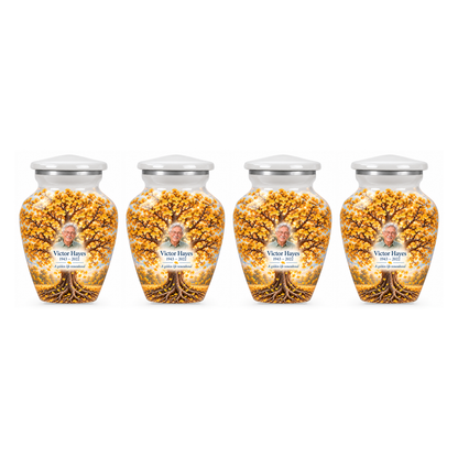 Four matching Golden Ginkgo Tree of Life keepsake urns with sample photo and text on a white background