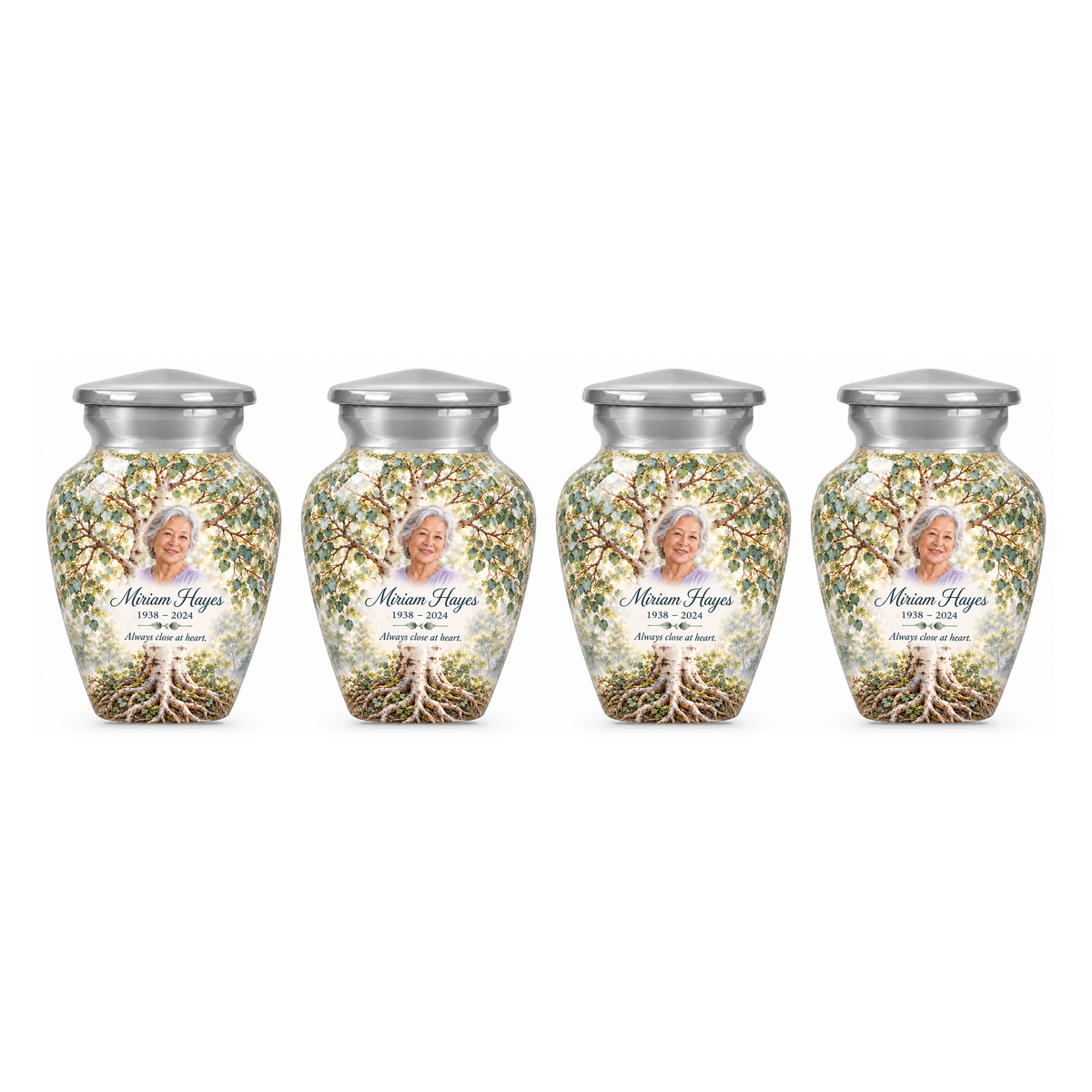 Four matching Silver Aspen Tree of Life keepsake urns with sample photo and text on a white background