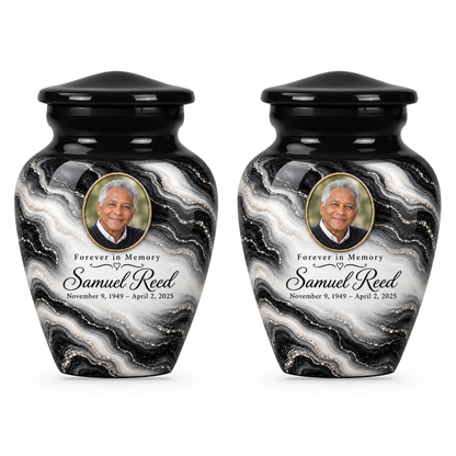 Two matching Black Pearl keepsake urns with sample portrait, name and dates.