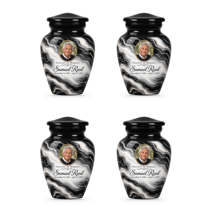 Four matching Black Pearl keepsake urns with sample portrait, name and dates.
