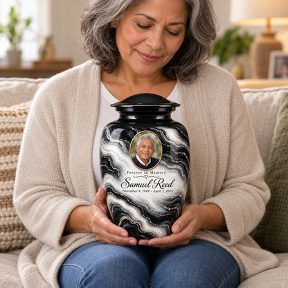An adult holds the Black Pearl photo urn on their lap, showing its scale.