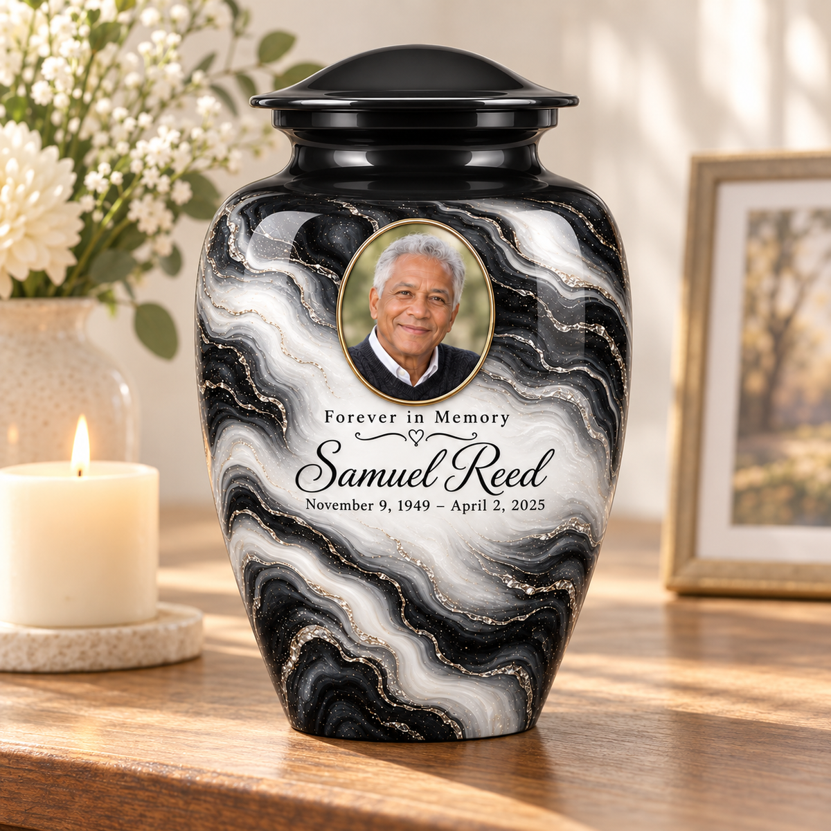 Black Pearl adult urn on a memorial console beside a candle and flowers.