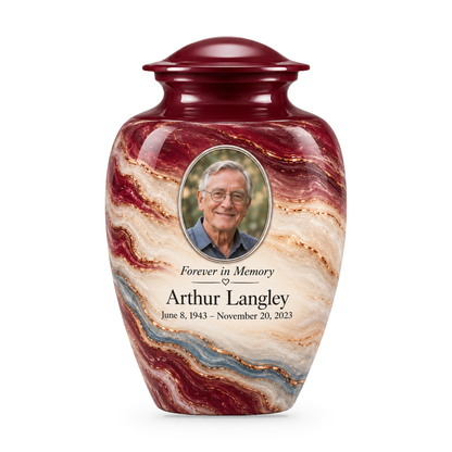 Burgundy Fold adult urn with wine and cream layers, a dusty-blue seam and sample portrait, name and dates.