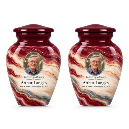 Two matching Burgundy Fold keepsake urns with sample portrait, name and dates.
