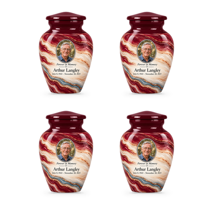 Four matching Burgundy Fold keepsake urns with sample portrait, name and dates.