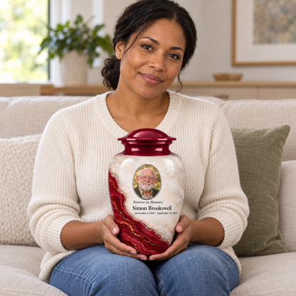 Bordeaux Shoreline adult urn held on a lap with fictional sample photo and text.